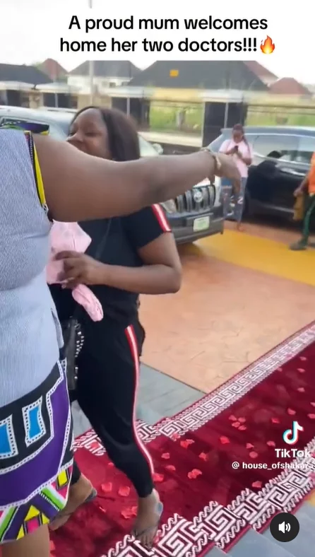 VIDEO: Proud mum rolls out red carpet as she welcomes her two children who bagged degrees in medicine