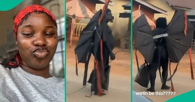 Lady who travelled to vllage shares video of strange masquerade that looks like batman on black